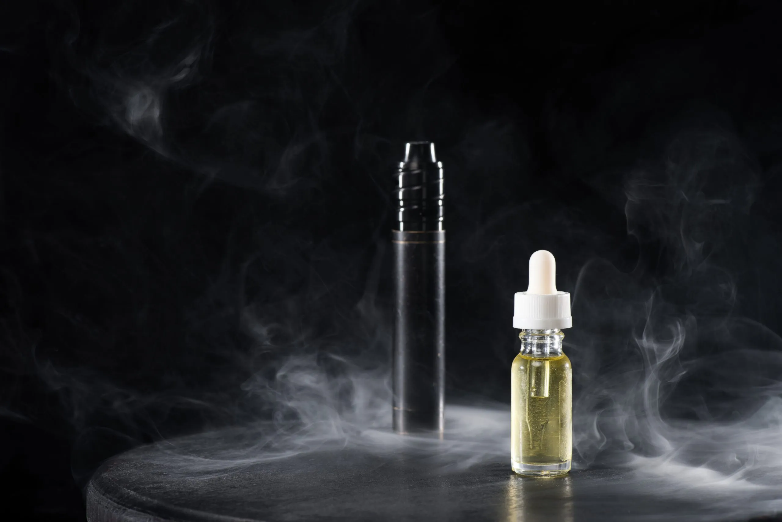 electronic-cigarette-and-liquid-with-clouds-of-smo-2021-08-29-19-41-04-utc-scaled