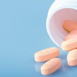 orange-pills-on-blue-background